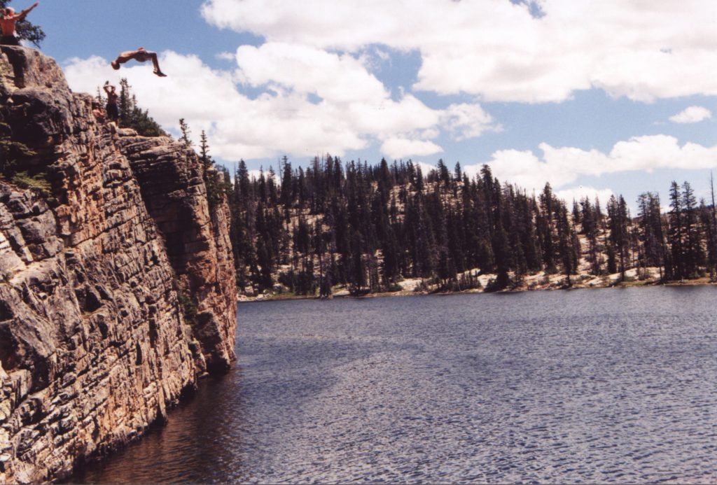 Man jumping off of a cliff into Island Lake